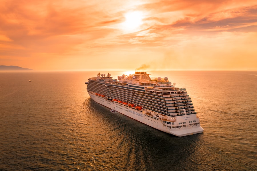 Cruise ship at sea under a golden sunset sky