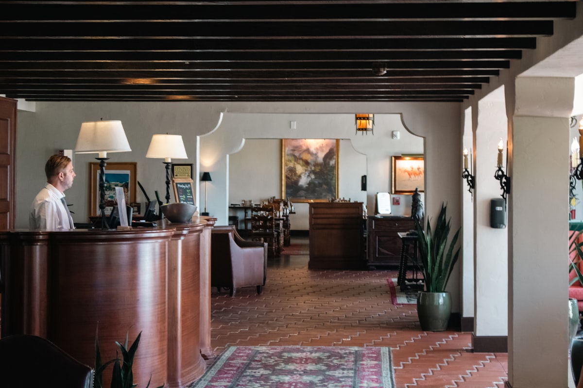 Warm, welcoming hotel lobby with a concierge desk