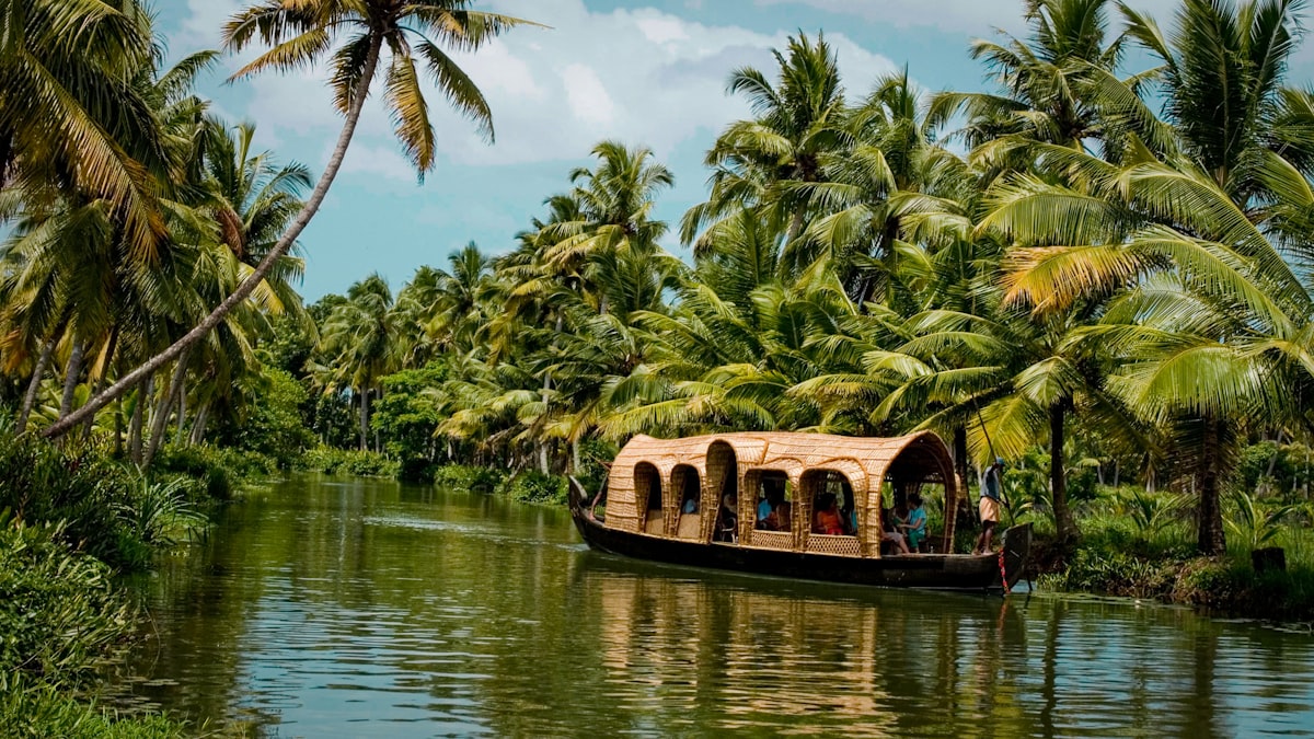 Traditional houseboat drifting through palm-fringed Kerala backwaters