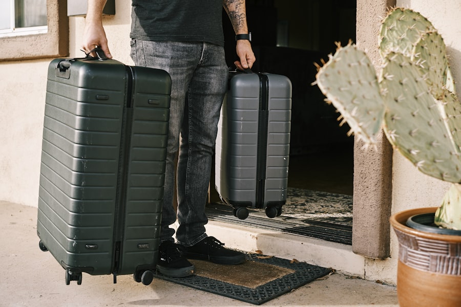 Traveller with two suitcases at a doorway
